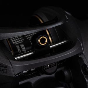 Close-up of the VoltiQ baitcasting reel from the front view showing the eyelet the line will feed through, with the reel behind it.