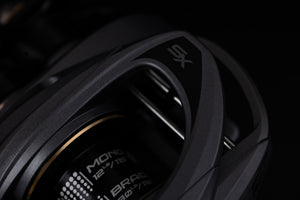 Close up of the  Abu Garcia VoltiQ SX fishing reel from above. Darkend picture on a black background.